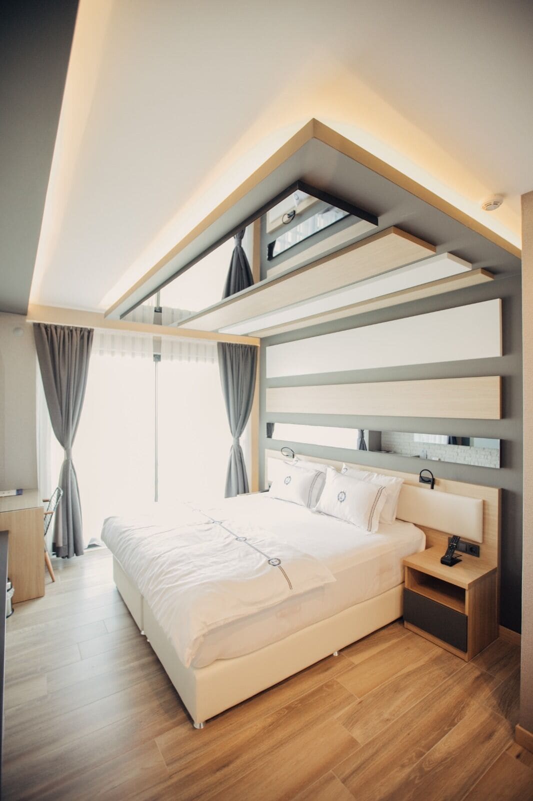 Ein modernes Schlafzimmer mit einem großen Bett, Einbauschränken und einem Oberlicht.
