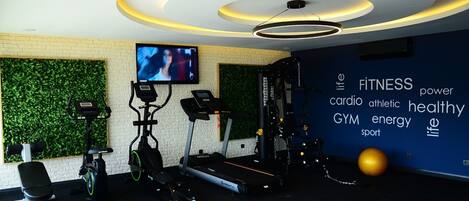 A modern gym with treadmills, an elliptical, and a stationary bike.