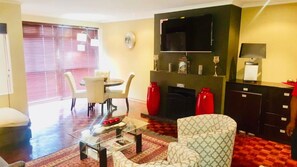 Penthouse, 3 Bedrooms, Sea View | Living room | 65-inch Smart TV with satellite channels, TV, fireplace - Beachview Penthouse (Gqeberha (Port Elizabeth))