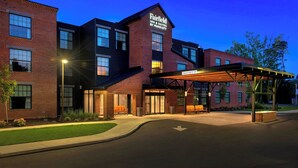 A Fairfield Inn & Suites by Marriott hotel with a brick facade, large windows, and a covered outdoor seating area. - Fairfield Inn & Suites by Marriott Williamstown (Williamstown)