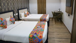 A hotel room with two beds, a desk, and a TV. - S.R Residency (Dera Bassi)