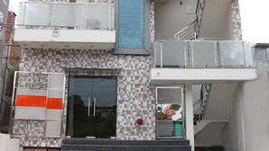 A multi-story building with balconies, a staircase, and a glass entrance. - S.R Residency (Dera Bassi)