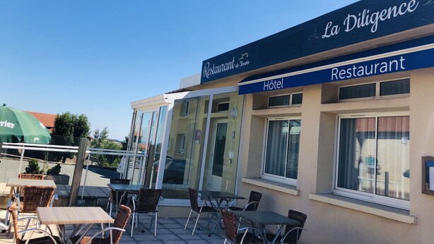 A restaurant named "La Diligence" with outdoor seating and a sign indicating it is also a hotel. - Hôtel Restaurant La Diligence (Le Brignon)