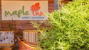 A sign with the text "Maple Inn" and the words "comfort" and "convenience" below it. - Maple Inn Hotel (Ruiru)