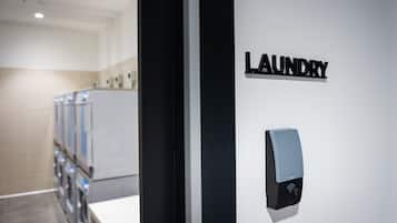 A modern interior with a sign reading "LAUNDRY" and a wall-mounted device, likely a sensor or control panel.