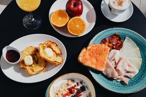 A breakfast setting with toast, fruit, cheese, and a cup of coffee. - Bidaia Boutique Hotel (San Sebastián)