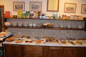 A buffet setup with various food items and condiments.