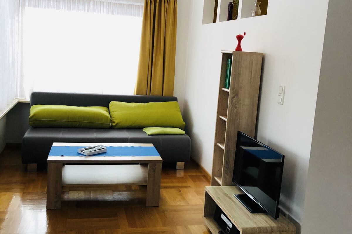 Apartment, Garden View (Benjamin) | Living area | 100-cm flat-screen TV with cable channels, TV, DVD player