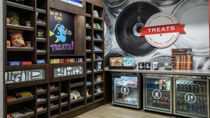 A snack and treat display area with shelves stocked with various snacks and a refrigerated section with beverages. - Hampton Inn Black Mountain (Black Mountain)