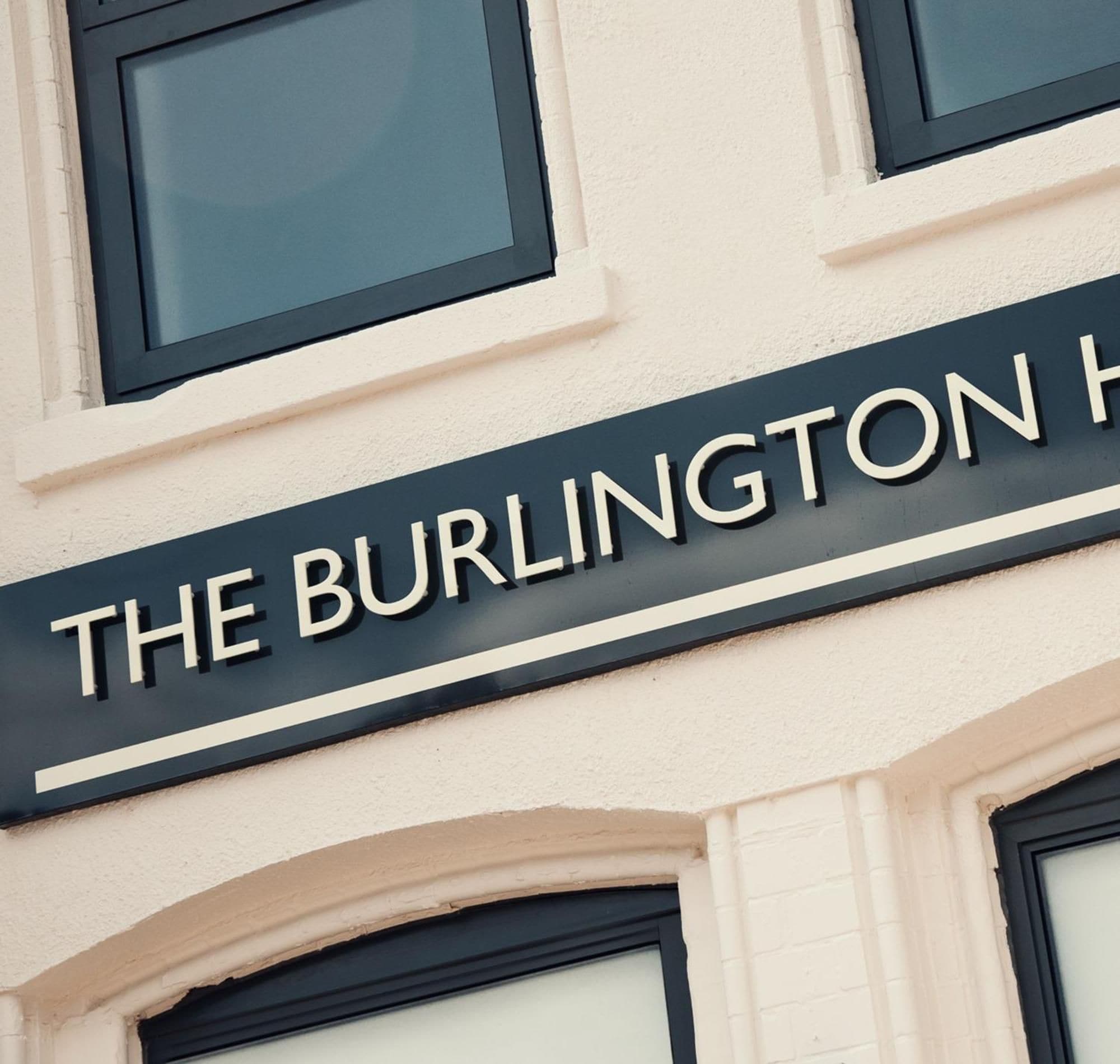 A building with a sign that reads 'THE BURLINGTON H.'