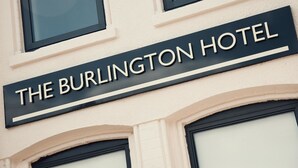 A sign for "The Burlington Hotel" with a classic architectural design, featuring arched windows and a clean facade. - The Burlington Hotel (Cleethorpes)