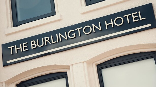 A sign for "The Burlington Hotel" with a classic architectural design, featuring arched windows and a clean facade. - The Burlington Hotel (Cleethorpes)