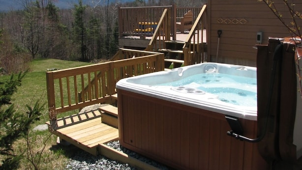 A hot tub on a wooden deck with a view of mountains. - Franconia Notch Retreat, Huge Views, Hot Tub, EV charger, A/C (Sugar Hill)
