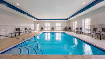 Una piscina techada, sillones reclinables de piscina