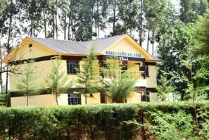 A yellow building with a sign reading "MBASU ORUKO KULAKHA VILLA". - Malava Forest Lodge (Kakamega)