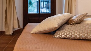 A bedroom with a bed, beige curtains, a window, and a framed picture on the wall. - La Verena (Vesime)