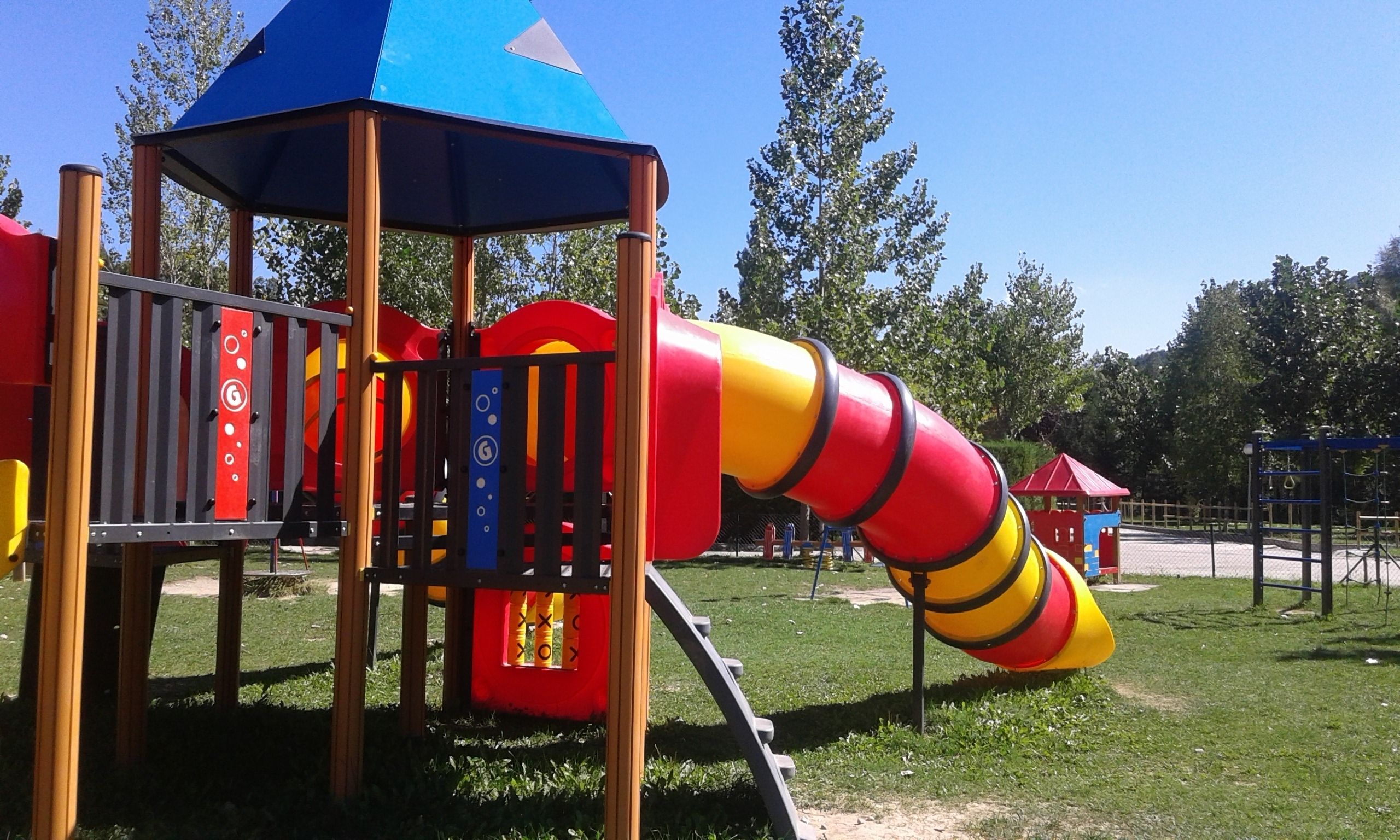 A playground with a slide and climbing structures.