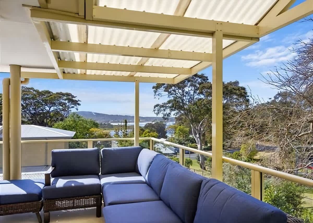 A covered outdoor seating area with a view of the surrounding landscape.