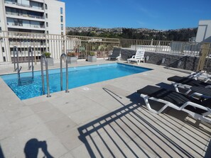 Seasonal outdoor pool, open 10:00 AM to 8:00 PM, pool loungers