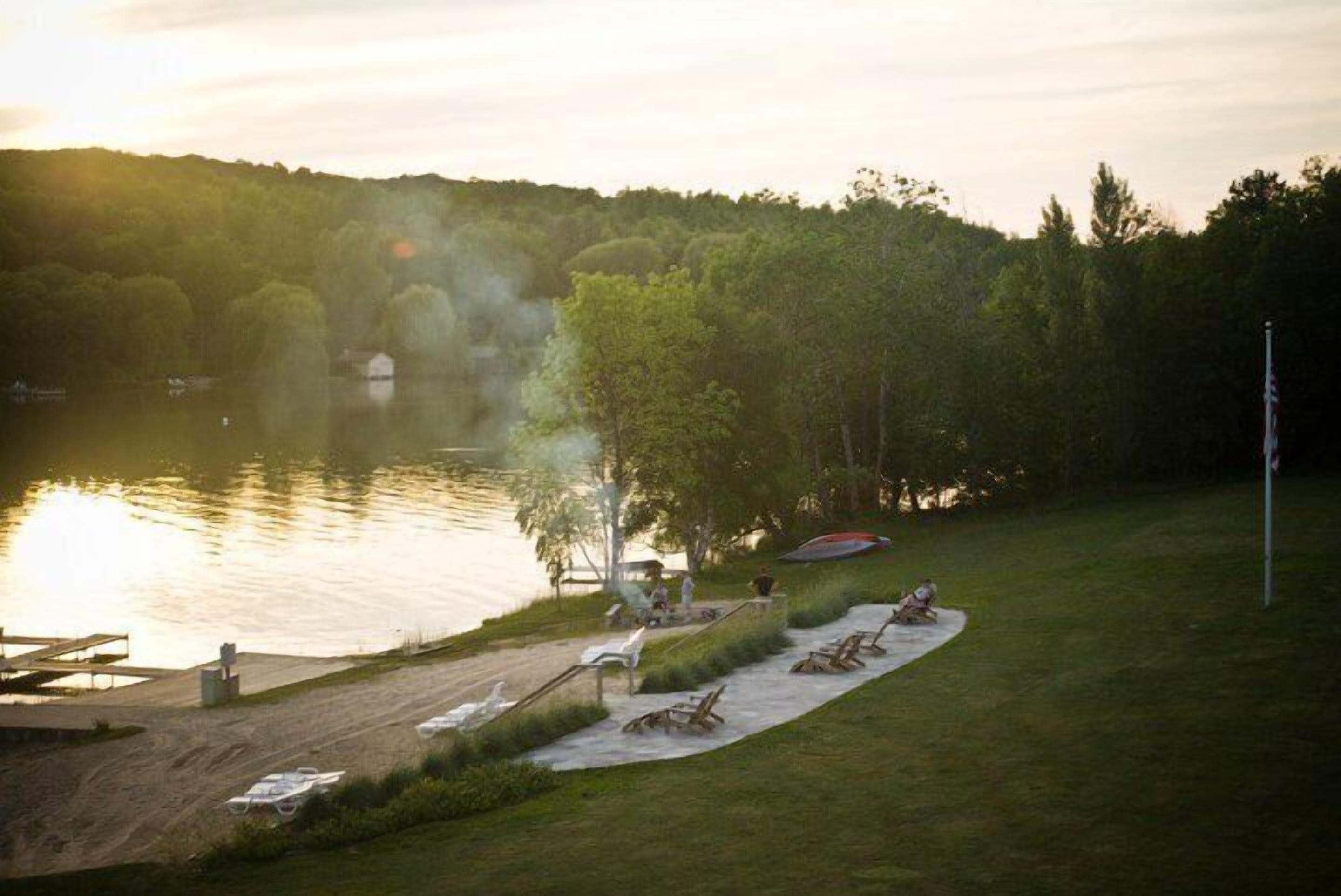 Un cadre idyllique au bord du lac, avec un quai, des chaises longues et un espace pique-nique.