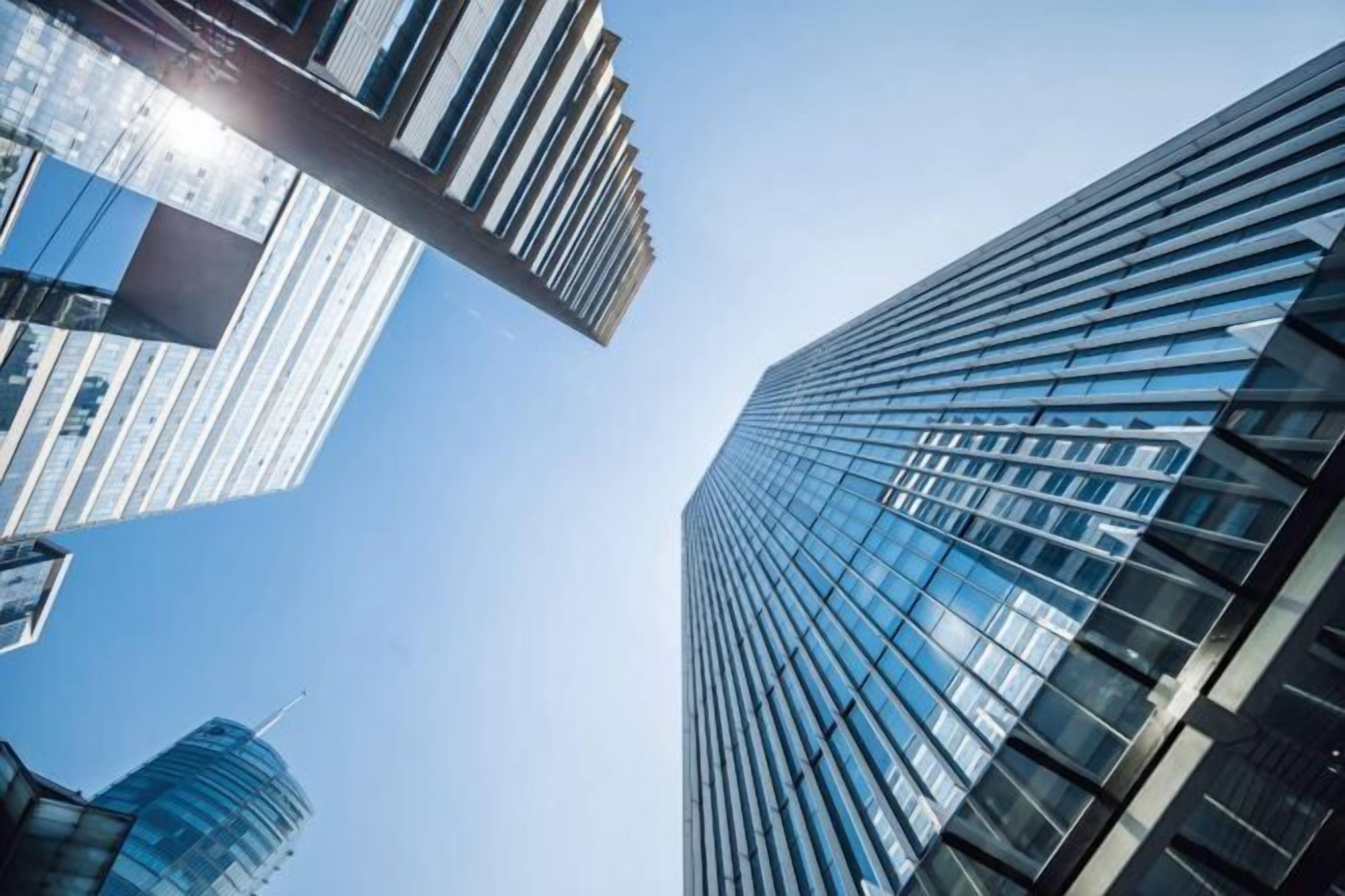 A high-rise building with a modern glass facade and a prominent vertical structural element.