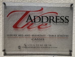 A sign for 'The Address' hotel, indicating it offers luxury bed and breakfast services. - The Address Cassis (Cassis)