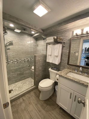 Shower, hair dryer, towels, toilet paper