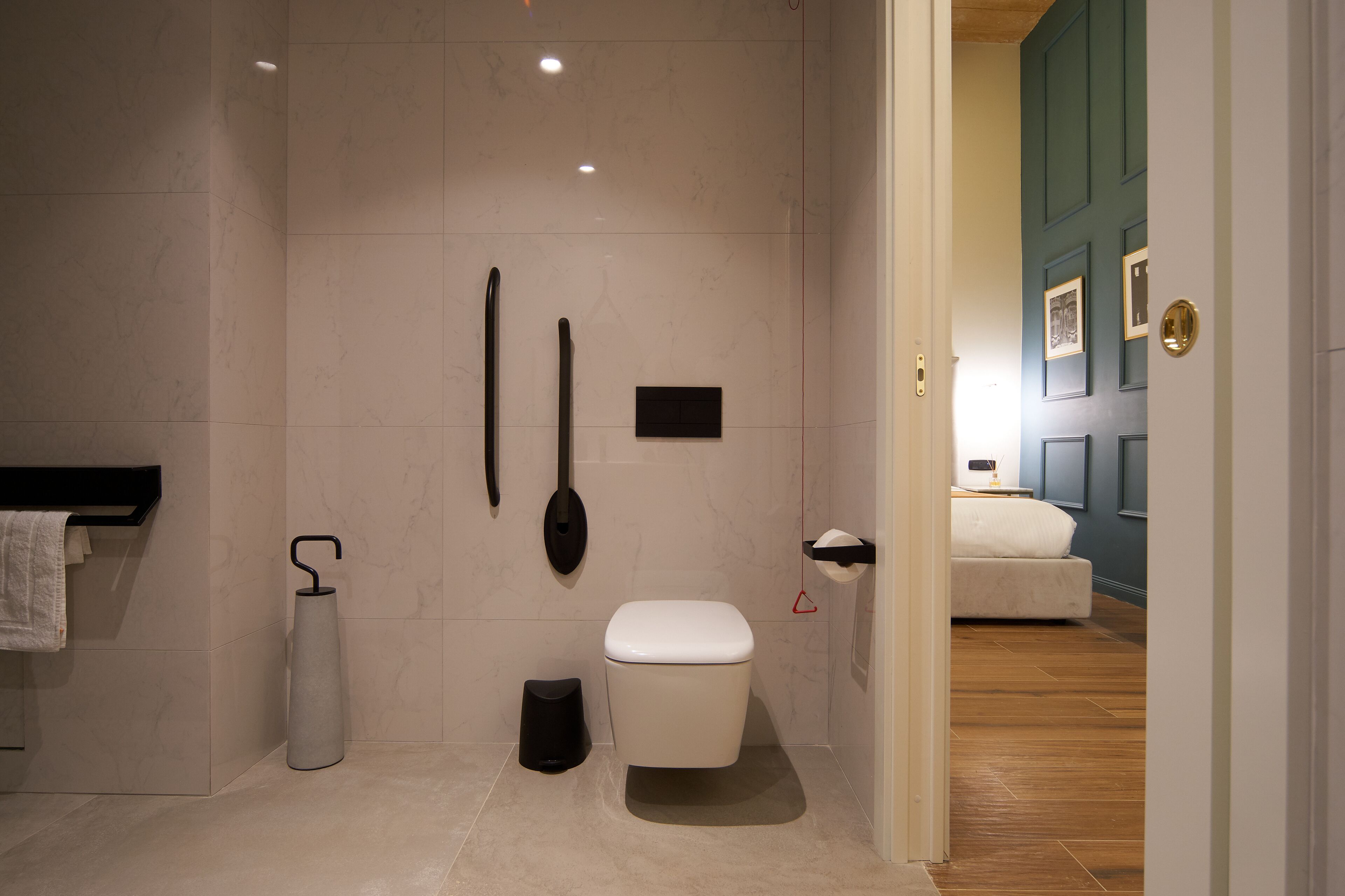 Ein modernes Badezimmer mit Toilette, Bidet und Handtuchhalter.
