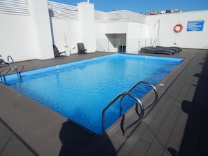 Seasonal outdoor pool, pool loungers