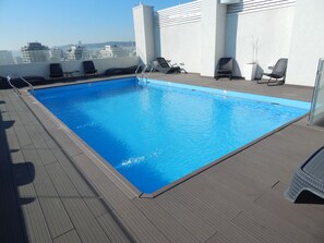 Seasonal outdoor pool, open 9:00 AM to 8:00 PM, pool loungers