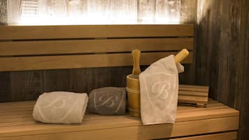 A wooden bench with towels and a wooden brush.