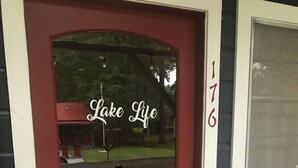 A red front door with a glass window, a mailbox, and a welcome sign. - “Lake Life” - Boat ramp here (Broaddus)