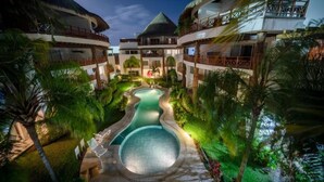 A resort with multiple buildings, a central pool, and lush greenery. - Xaman 201   by NAS (Playa del Carmen)