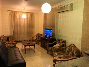 Apartment, 2 Bedrooms, Sea View | Living room | Flat-screen TV
