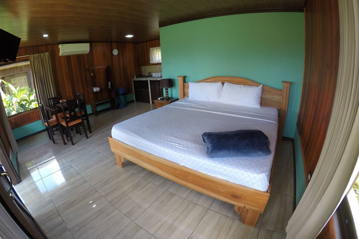 A room with a bed, a desk, and a chair.