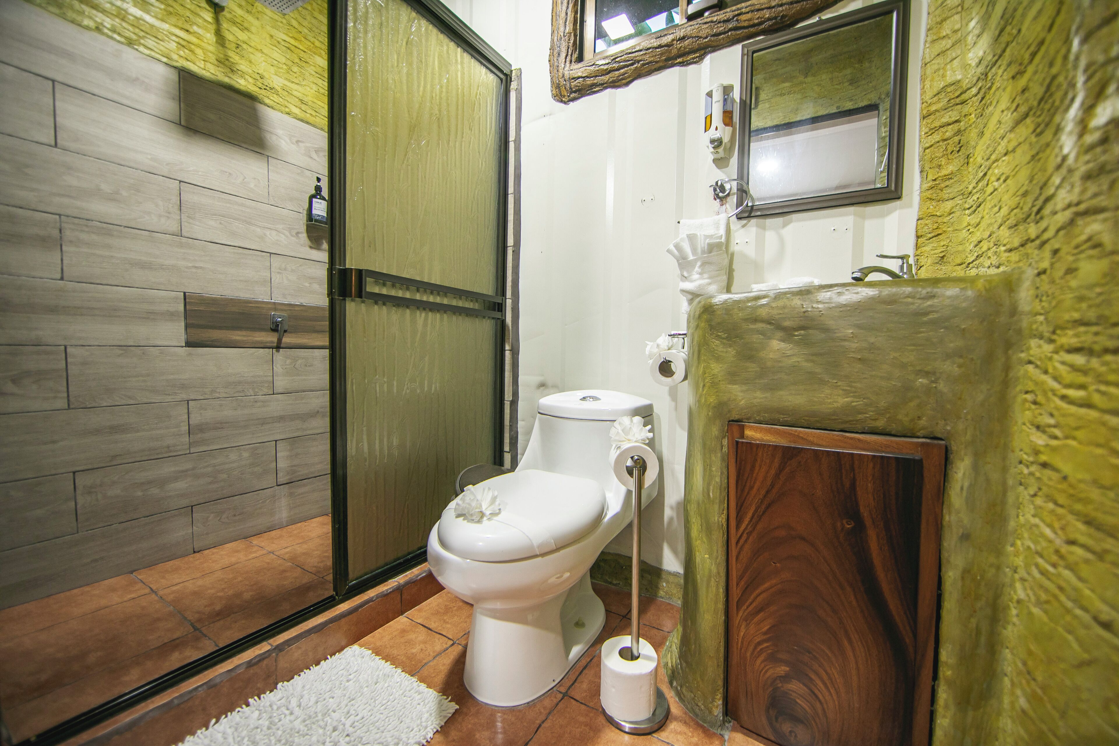 A bathroom with a toilet, bidet, and a shower area.