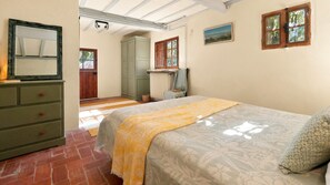 A bedroom with a bed, a dresser, a radiator, and a window with a view. - Mountain Lodge - Taurinya (Taurinya)