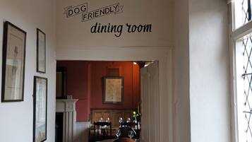 A dining room with a sign indicating it is dog friendly.