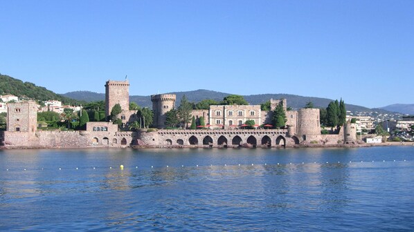 A historic castle with a moat, stone towers, and a bridge leading to the castle. - ADORABLE T1 ALCOVE RESIDENCE SECURE WITH 3 POOLS (Mandelieu-la-Napoule)