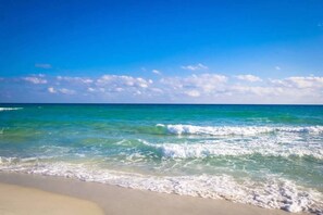 A beach with clear blue water and a sandy shore. - Gulf Shores 2 bedroom 2 bath condo in SeaBreeze!  (Gulf Shores)
