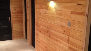 A hallway with wooden paneling and a tiled floor. - Boutique Alpine Chalet with Panoramic Views next to Ski Lift (Thollon-Les-Mémises)