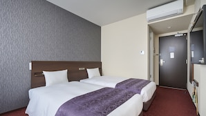 A hotel room with two beds, a grey textured wall, a red carpet, and a door with a mirror and a TV. - HOTEL AXIA INN SAPPORO SUSUKINO  (Sapporo)