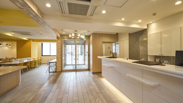 A modern kitchen with a marble floor, wooden cabinets, and a large island with a sink. - HOTEL AXIA INN SAPPORO SUSUKINO  (Sapporo)