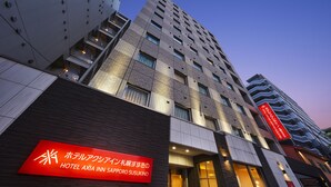 A modern hotel building with a prominent red sign indicating it is the Hotel Axia Inn Sapporo Susukino. - HOTEL AXIA INN SAPPORO SUSUKINO  (Sapporo)