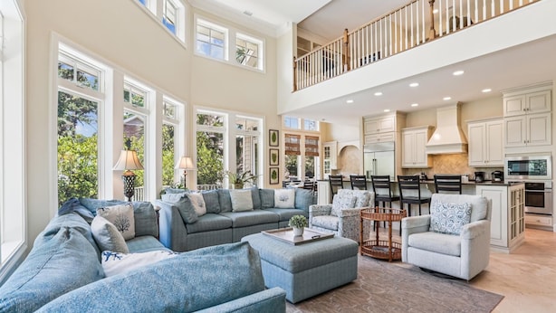 A spacious living area with a large sectional sofa, a coffee table, and a dining area with chairs. - Beautiful & Spacious 5br Home w/ Private Pool (Hilton Head Island)