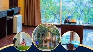 A hotel room with a large window, a desk, and a chair. - Ha Noi Le Grand Hotel (Hanoi)