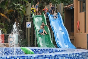 A water park with two slides and a pool area. - San Lameer Villa Rentals 10419 (Southbroom)