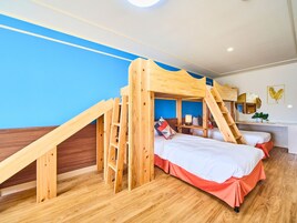 A room with a bunk bed, wooden ladder, desk, chair, and a mirror.