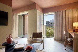 A modern hotel room with a balcony, a dining area, and a seating space.