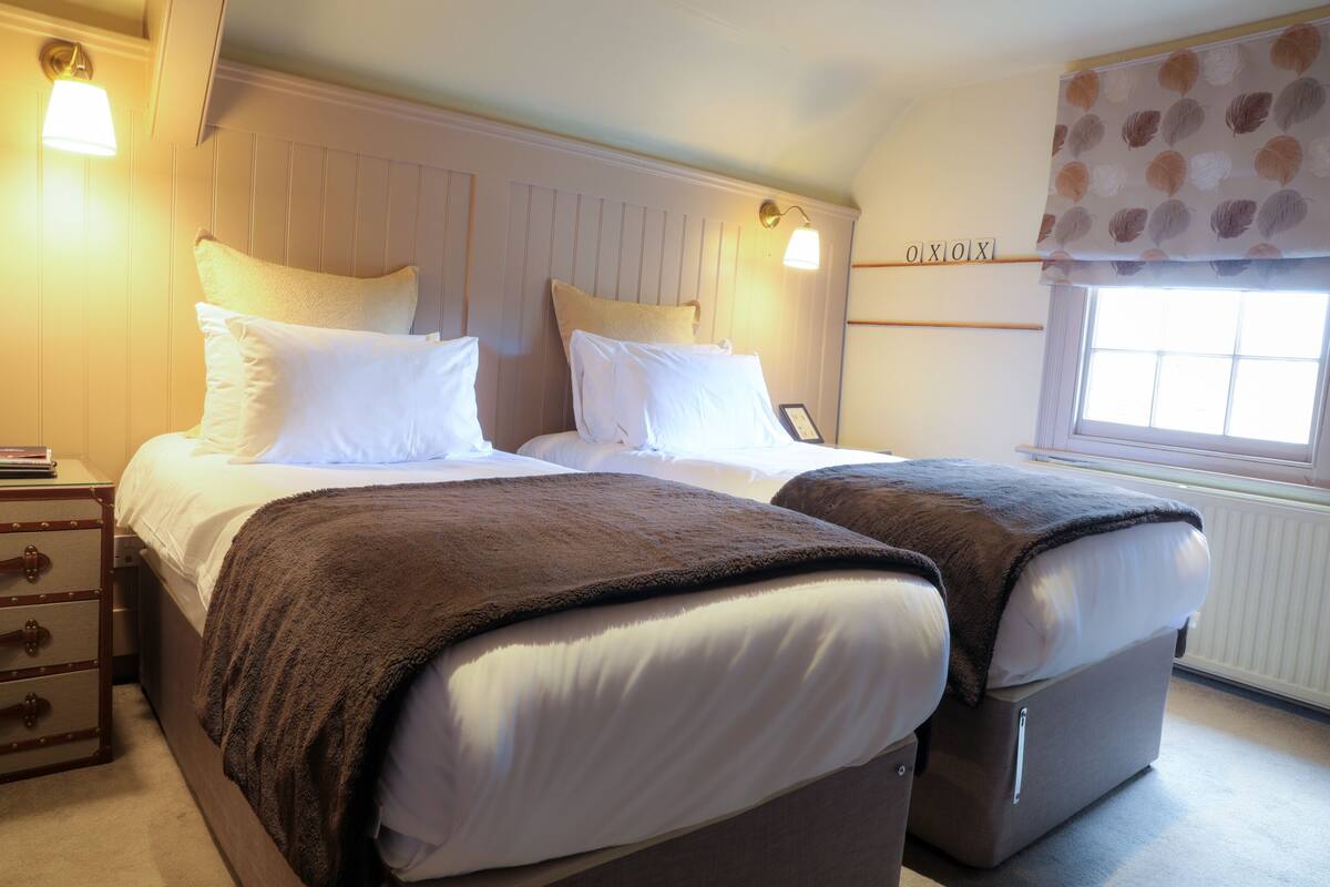 A double bed with a headboard, a bedside table, and a nightstand.